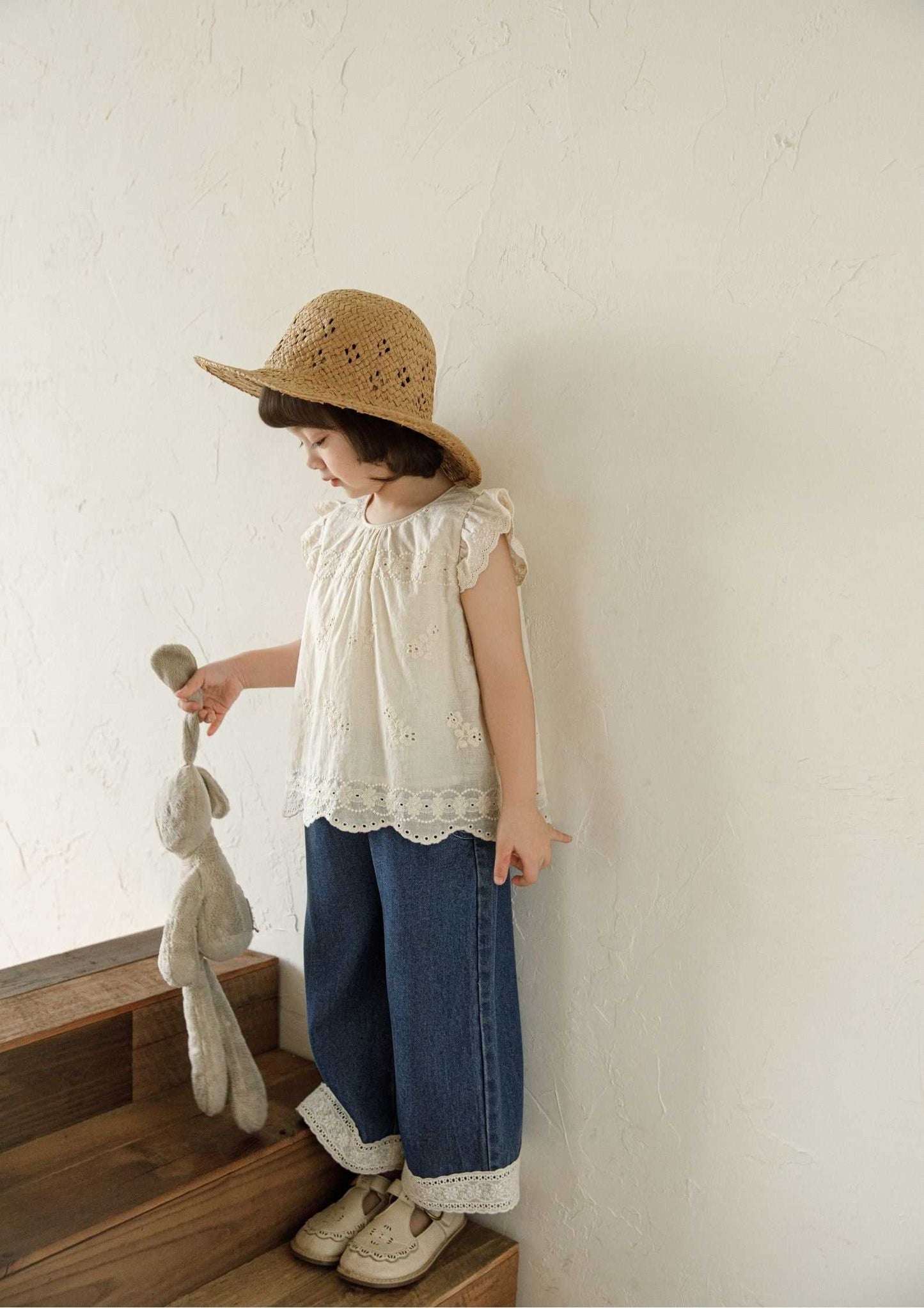 Beige girls sleeveless embroidered cotton top with floral design and ruffle sleeves
