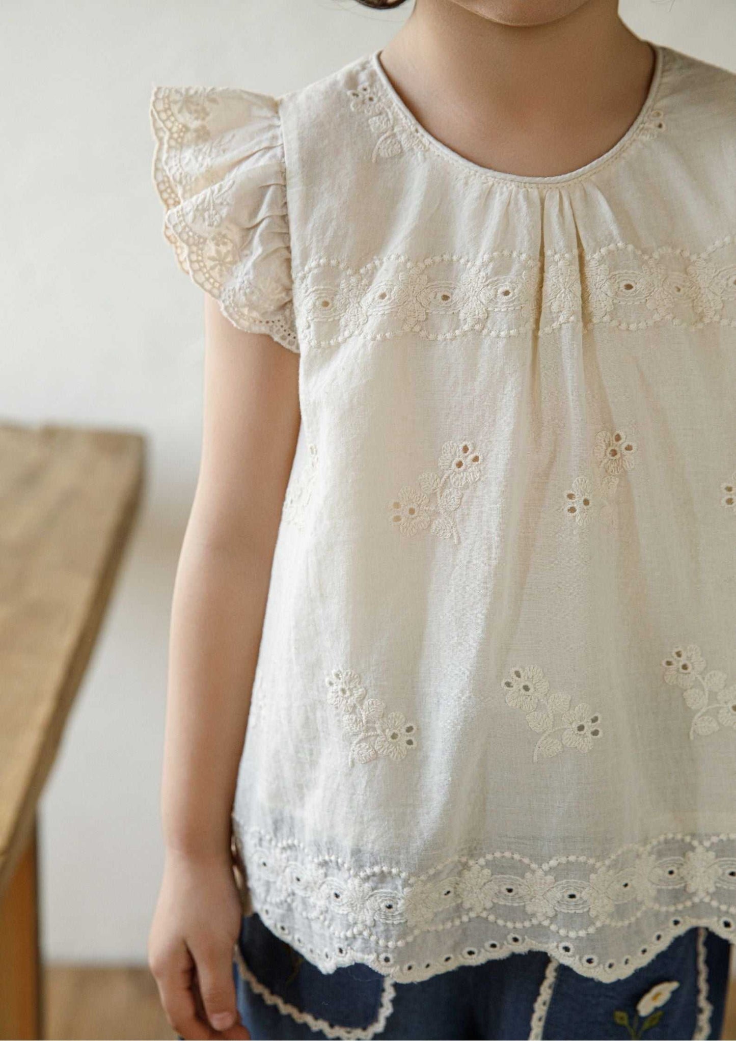 Girls embroidered cotton sleeveless beige floral top with ruffle sleeves and scalloped hem
