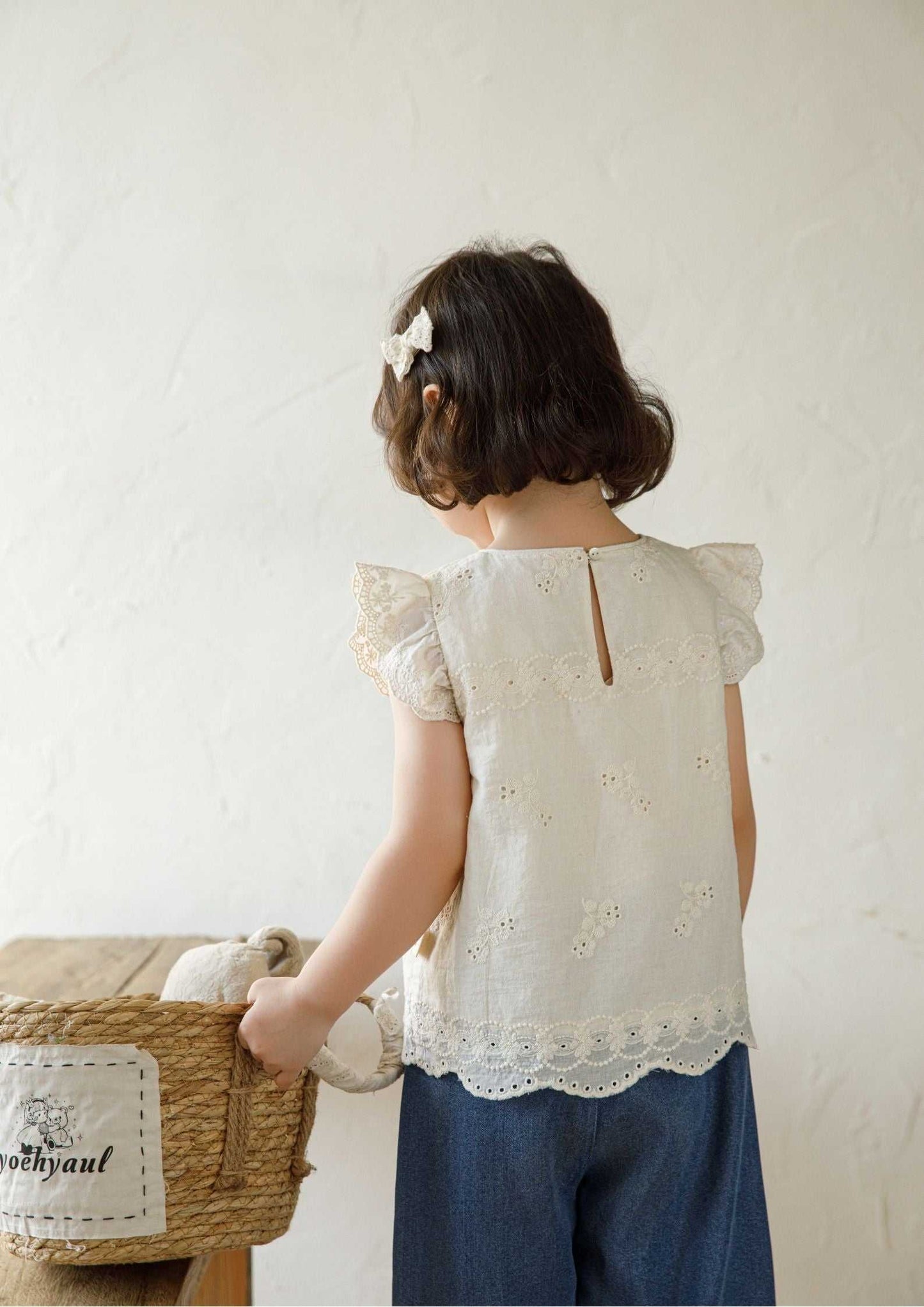 Beige girls sleeveless embroidered cotton top with floral design and ruffle sleeves