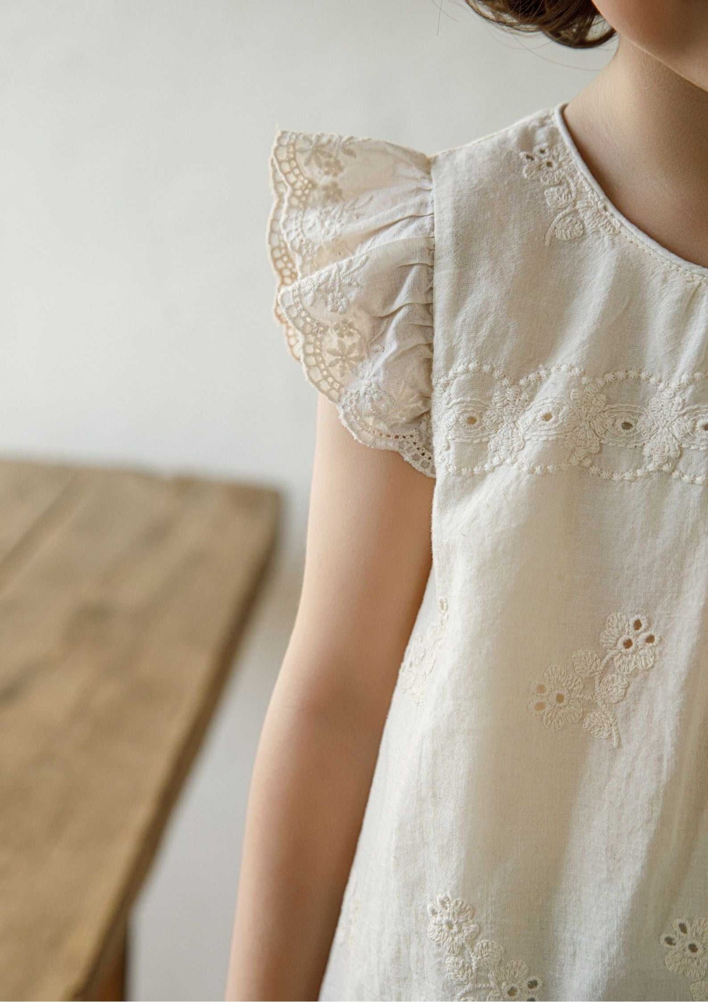 Girls embroidered cotton beige sleeveless top with floral embroidery and ruffle sleeves